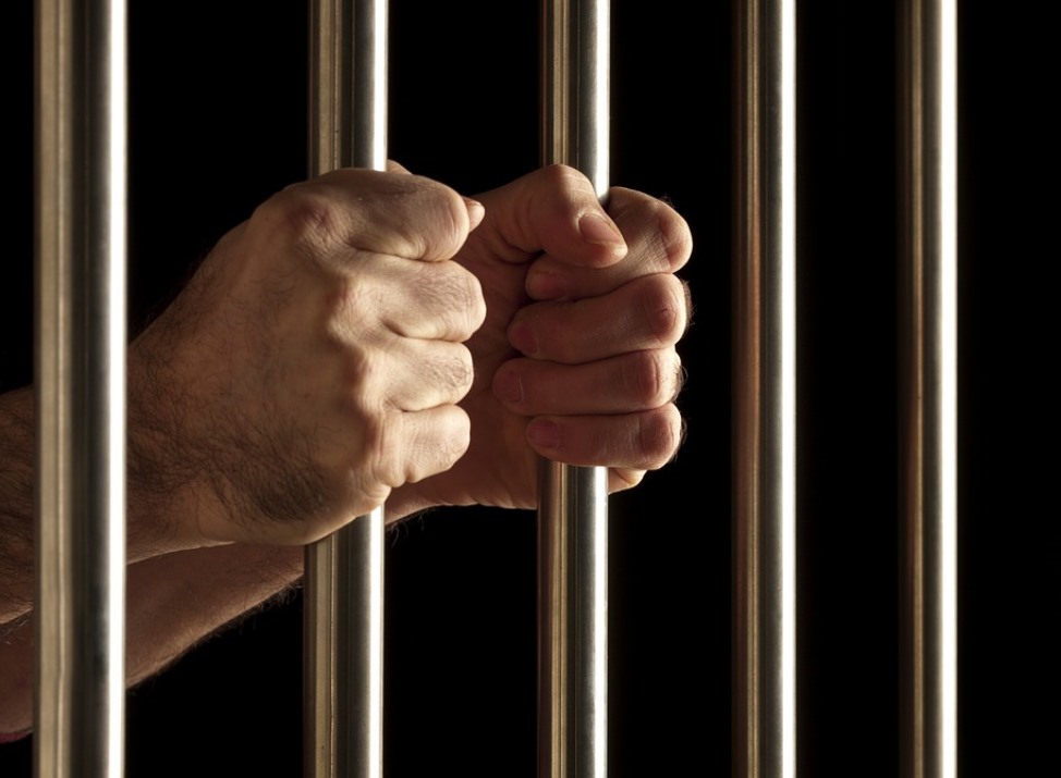 hands behind jail